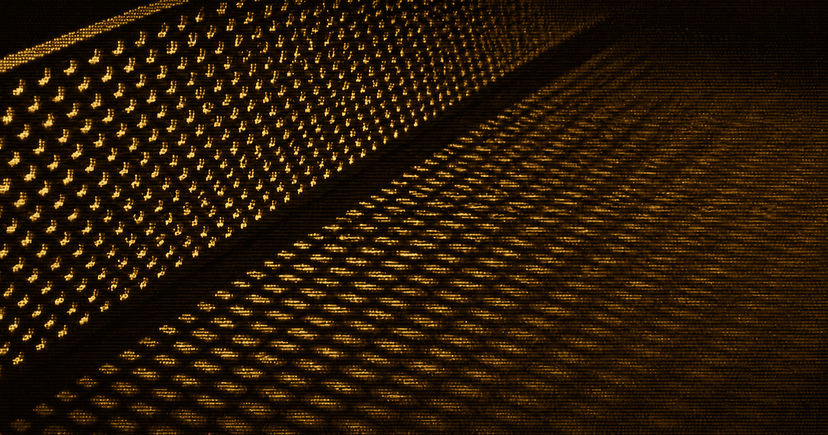 A perforated metal sheet viewed at an oblique angle casts a repeating pattern of light and shadow across a flat surface.