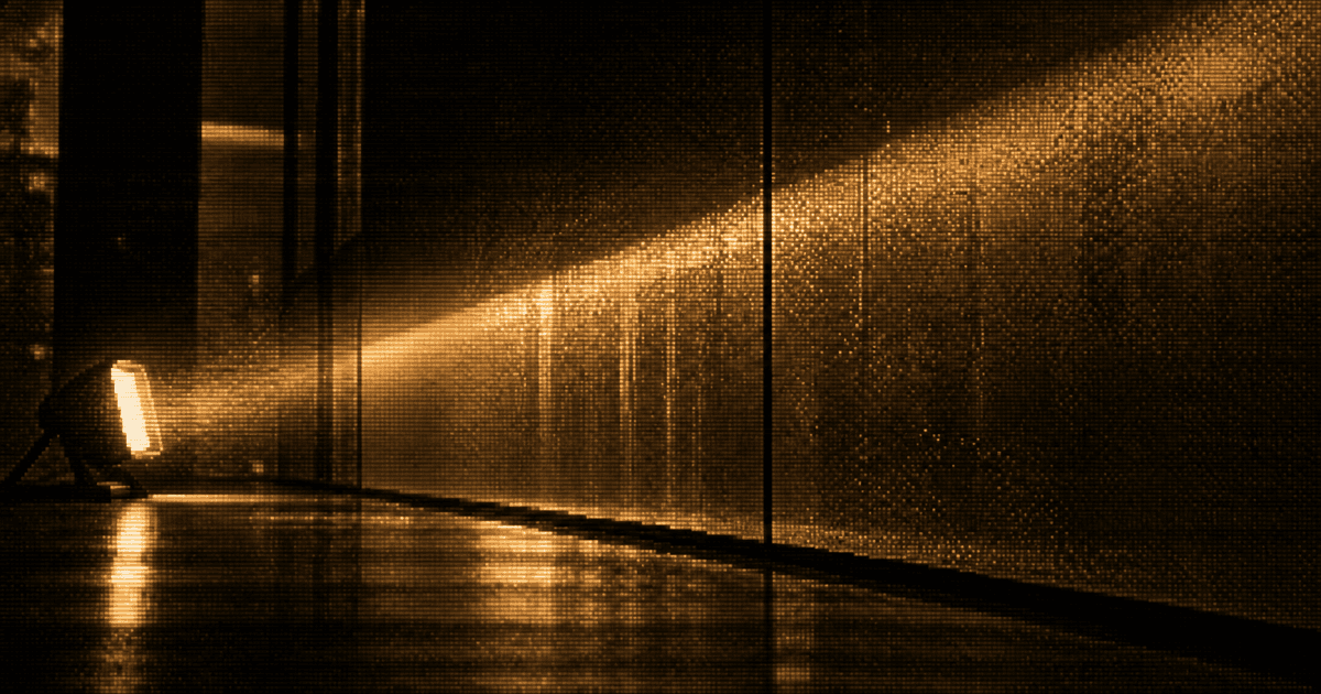A portable floodlight casts a narrow beam across a smooth finished wall.