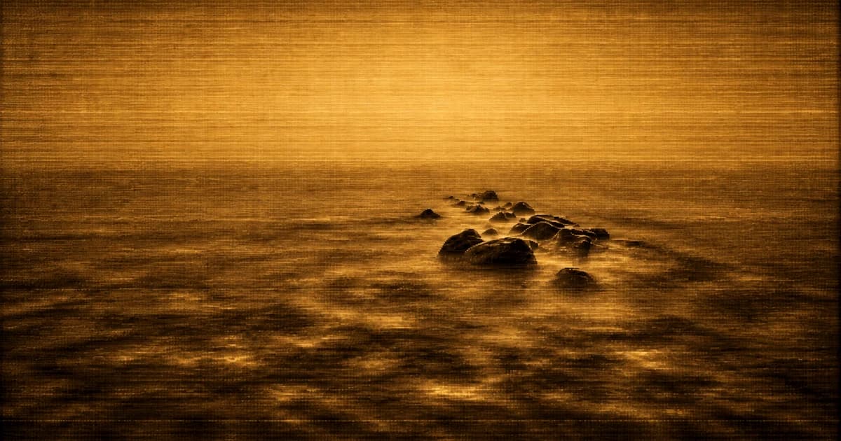 A misty seascape with a line of dark stepping stones beginning in the middle distance and extending toward the horizon, leaving open water in the foreground.